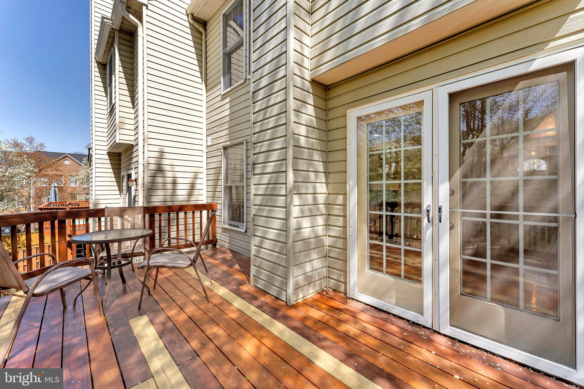 6556 Antrican Drive Springfield, VA 22150 - Photo 33 of 36 a view of a balcony with a floor to ceiling window and wooden floor