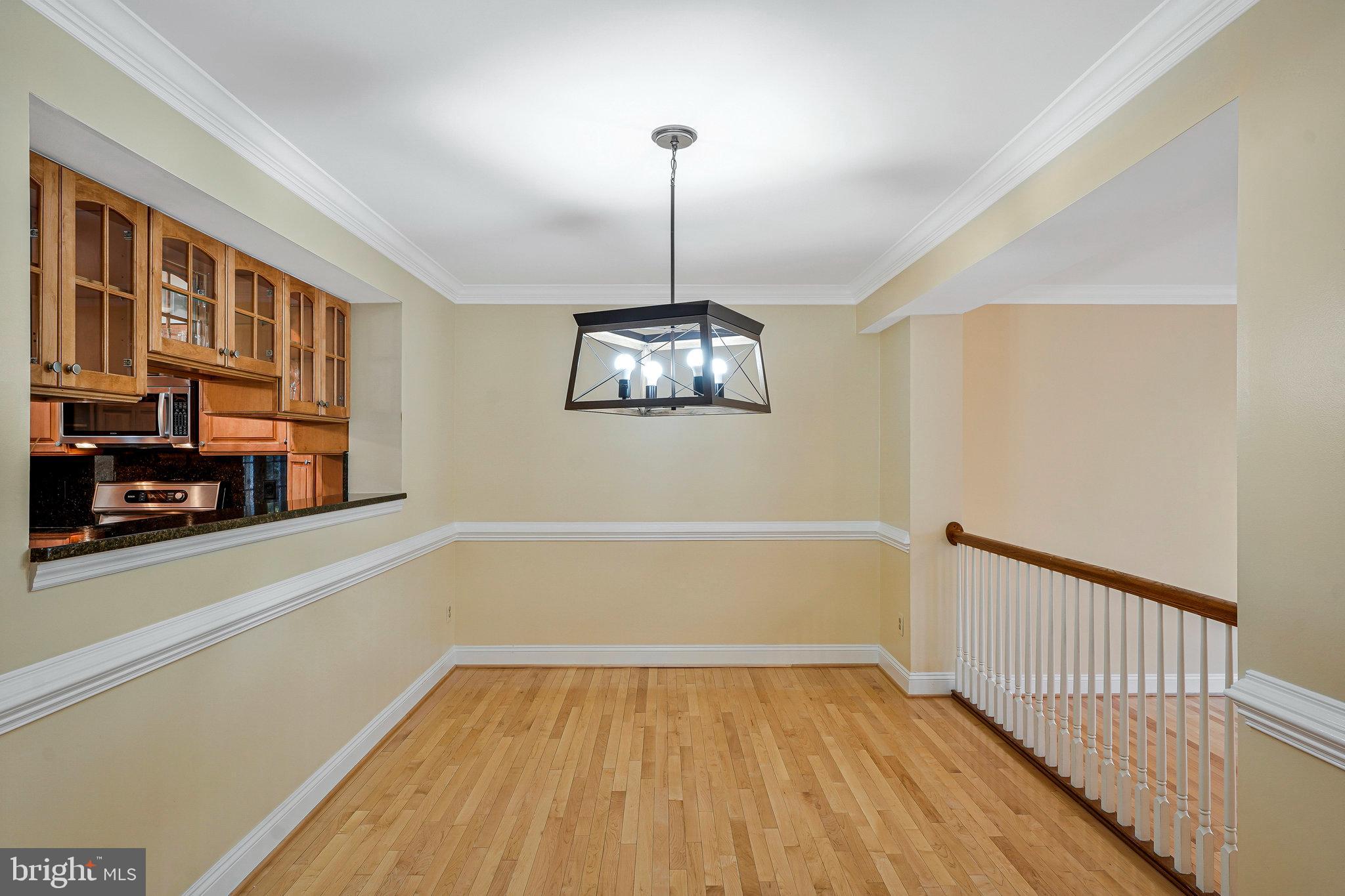 6556 Antrican Drive Springfield, VA 22150 - Photo 9 of 36 a view of a room with wooden floor cabinets and a chandelier
