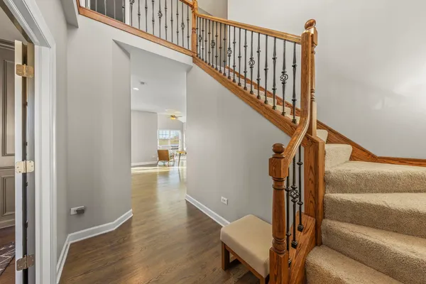 a view of entryway and hall with wooden floor