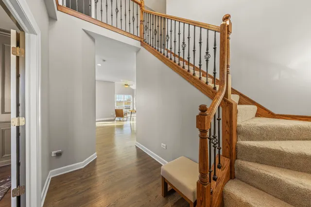 a view of entryway and hall with wooden floor