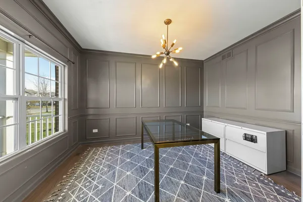 a kitchen with a stove and a white cabinet with granite countertops