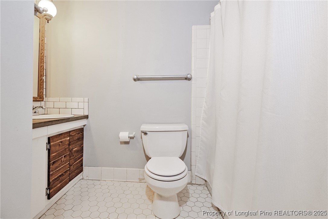 2818 Millbrook Road Fayetteville, NC 28303 - Photo 20 of 32 a white toilet sitting next to a shower