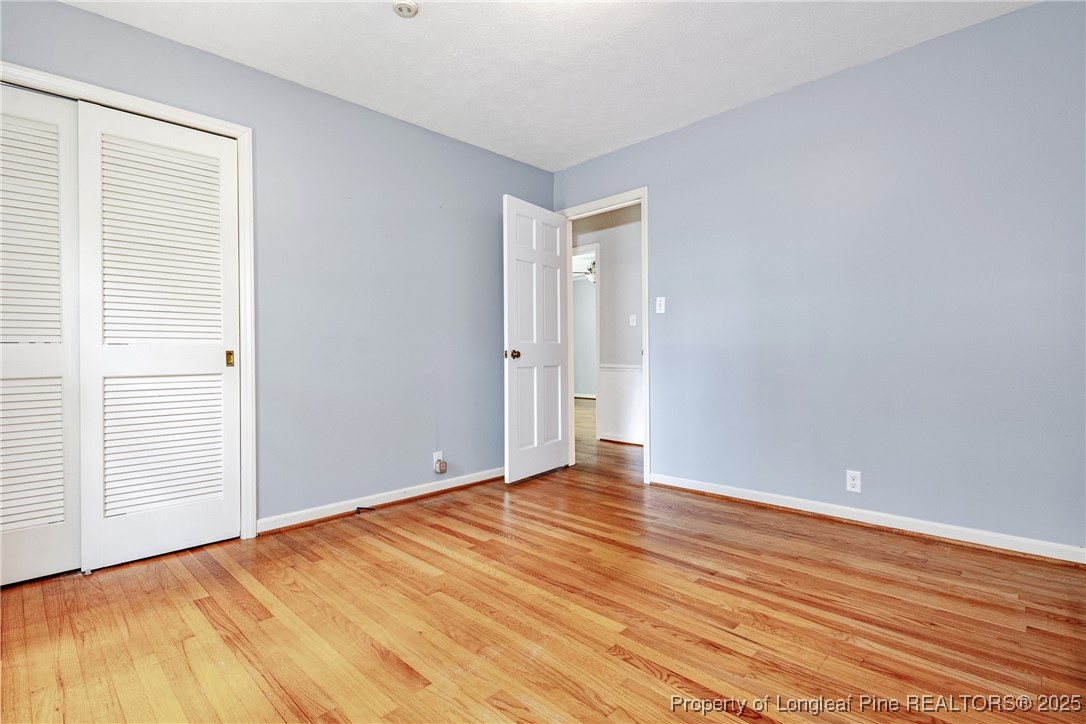 2818 Millbrook Road Fayetteville, NC 28303 - Photo 22 of 32 a view of an empty room with wooden floor