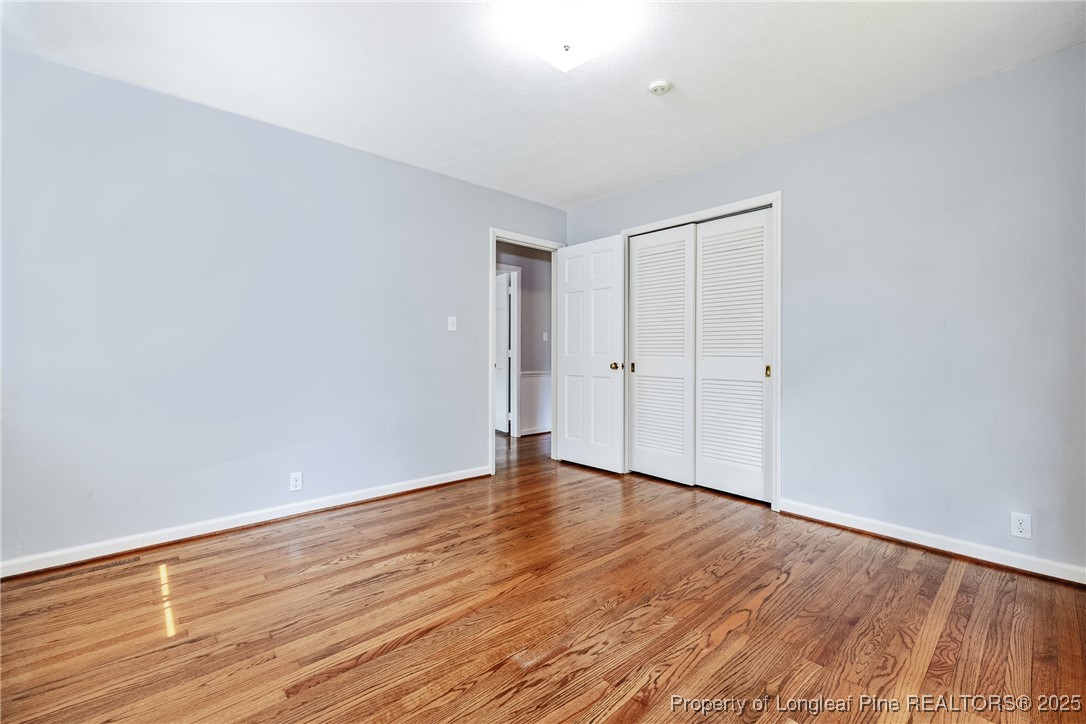 2818 Millbrook Road Fayetteville, NC 28303 - Photo 24 of 32 a view of an empty room with wooden floor