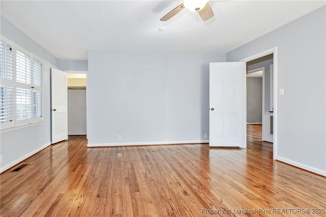 2818 Millbrook Road Fayetteville, NC 28303 - Photo 25 of 32 an empty room with wooden floor and windows