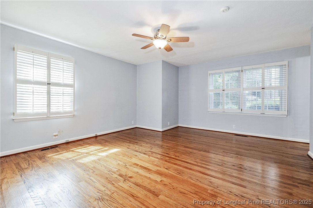 2818 Millbrook Road Fayetteville, NC 28303 - Photo 26 of 32 a view of an empty room with wooden floor and a window