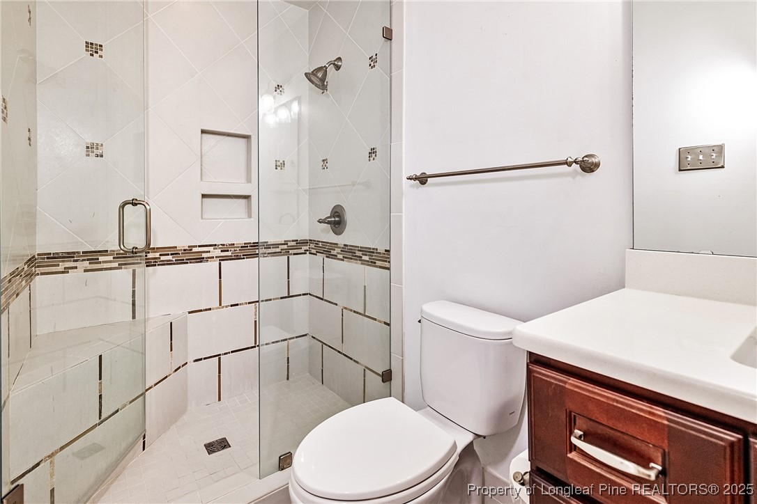 2818 Millbrook Road Fayetteville, NC 28303 - Photo 27 of 32 a bathroom with a sink a toilet and shower
