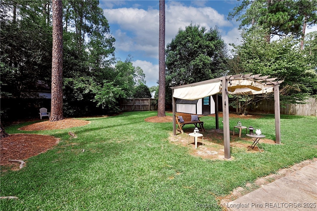 2818 Millbrook Road Fayetteville, NC 28303 - Photo 30 of 32 a view of a chair and table in backyard of the house