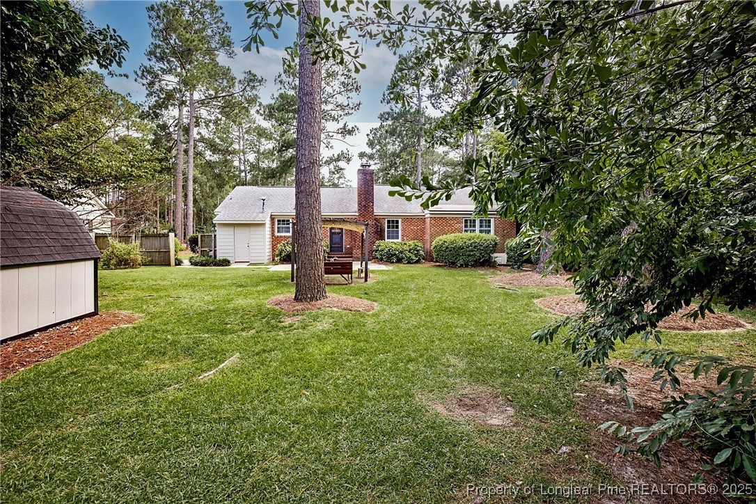 2818 Millbrook Road Fayetteville, NC 28303 - Photo 31 of 32 a view of a house with backyard and sitting area
