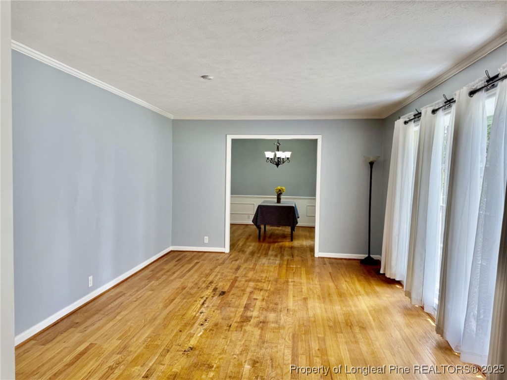 2818 Millbrook Road Fayetteville, NC 28303 - Photo 6 of 32 a view of a room with wooden floor and chair