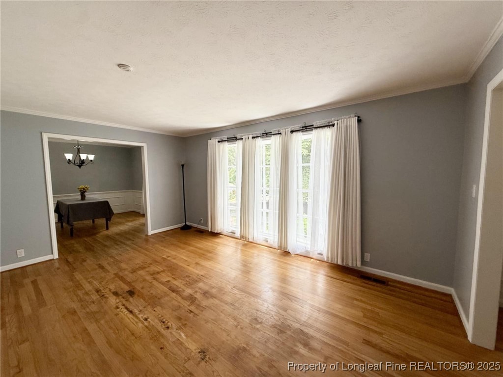2818 Millbrook Road Fayetteville, NC 28303 - Photo 8 of 32 a view of a room with wooden floor and a window