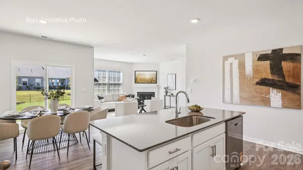 a kitchen with a sink cabinets and wooden floor