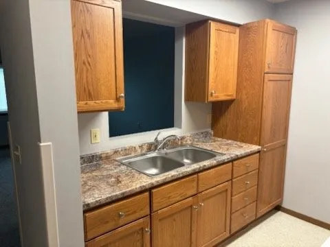 a bathroom with a sink a vanity and a window