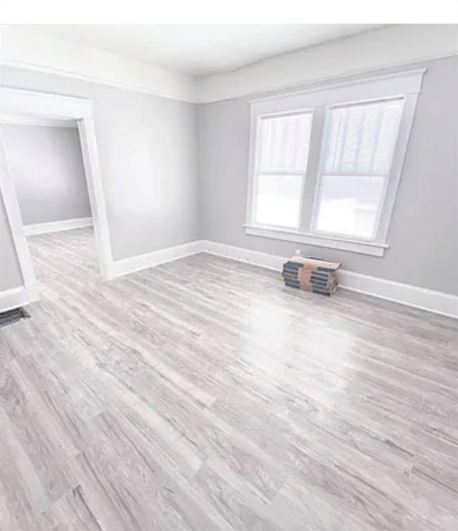1127 Metropolitan Parkway Southwest Atlanta, GA 30310 - Photo 12 of 23 an empty room with wooden floor and windows