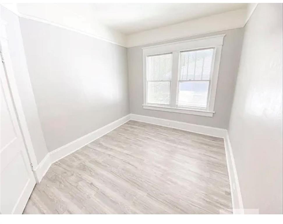 1127 Metropolitan Parkway Southwest Atlanta, GA 30310 - Photo 16 of 23 an empty room with wooden floor and windows