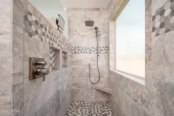 a bathroom with a granite countertop toilet a sink and a mirror