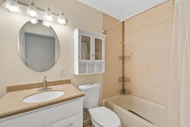 a bathroom with a sink a toilet and a mirror