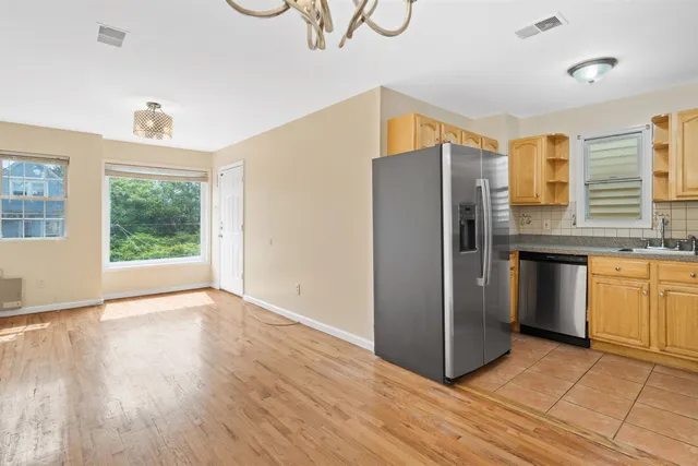 a kitchen with stainless steel appliances granite countertop a refrigerator and a sink