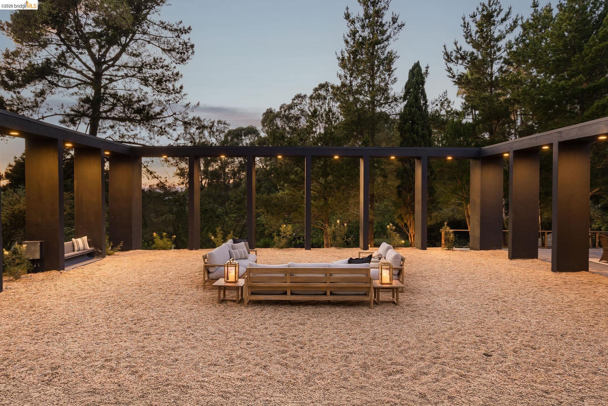 5645 Bacon Road Oakland, CA 94619 - Photo 80 of 94 Expansive outdoor patio area featuring a light-colored gravel surface and a dark-toned pergola structure