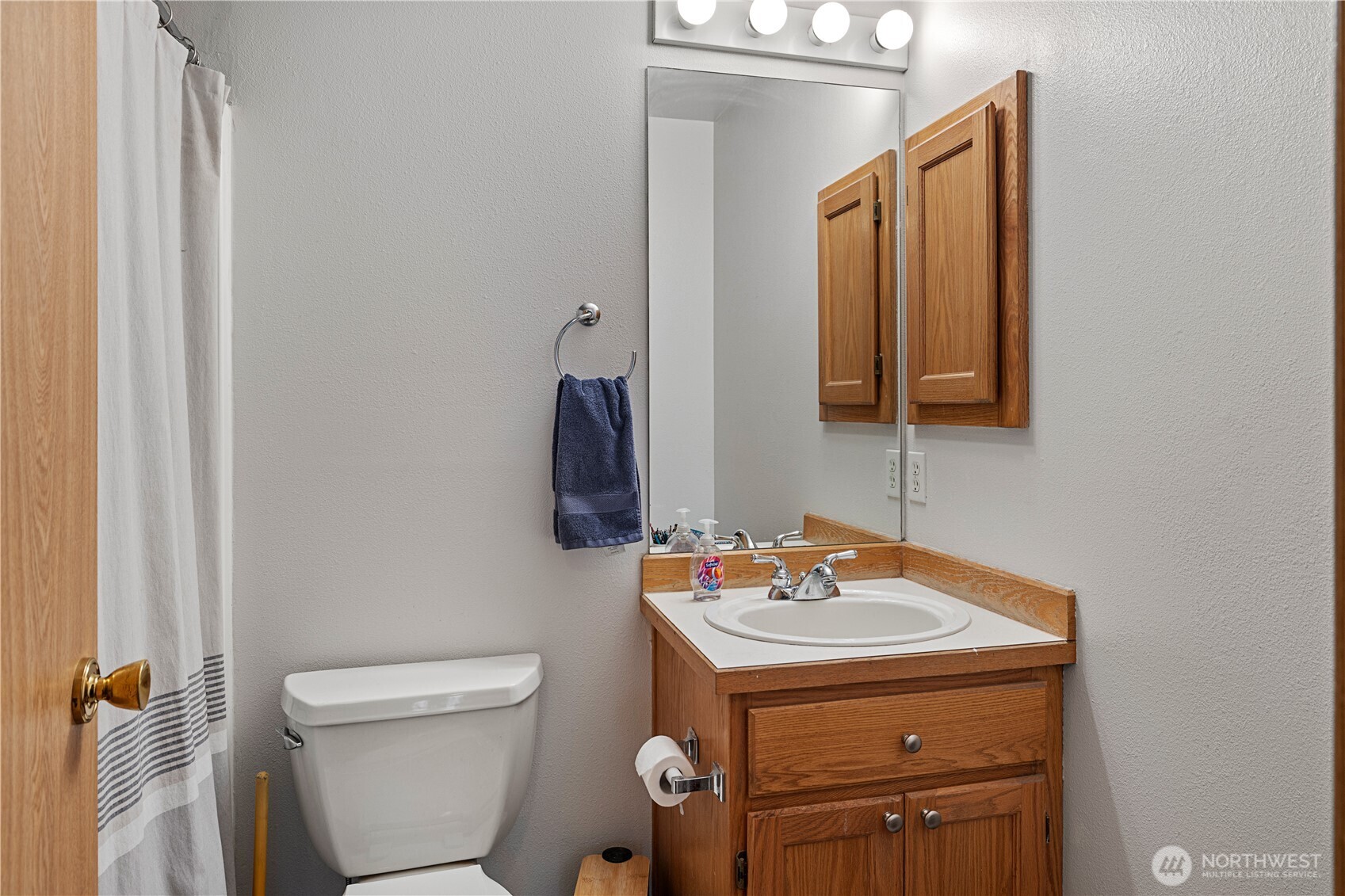 6352 24th Avenue Southwest Seattle, WA 98106 - Photo 12 of 31 a bathroom with a toilet sink and mirror