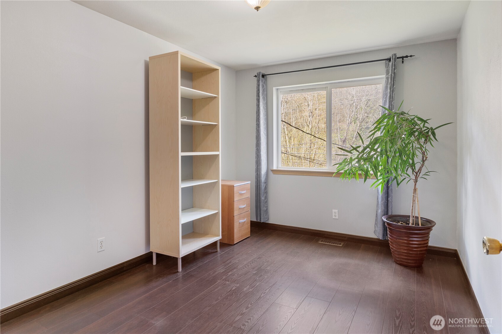 6352 24th Avenue Southwest Seattle, WA 98106 - Photo 13 of 31 a view of an empty room with a window and wooden floor