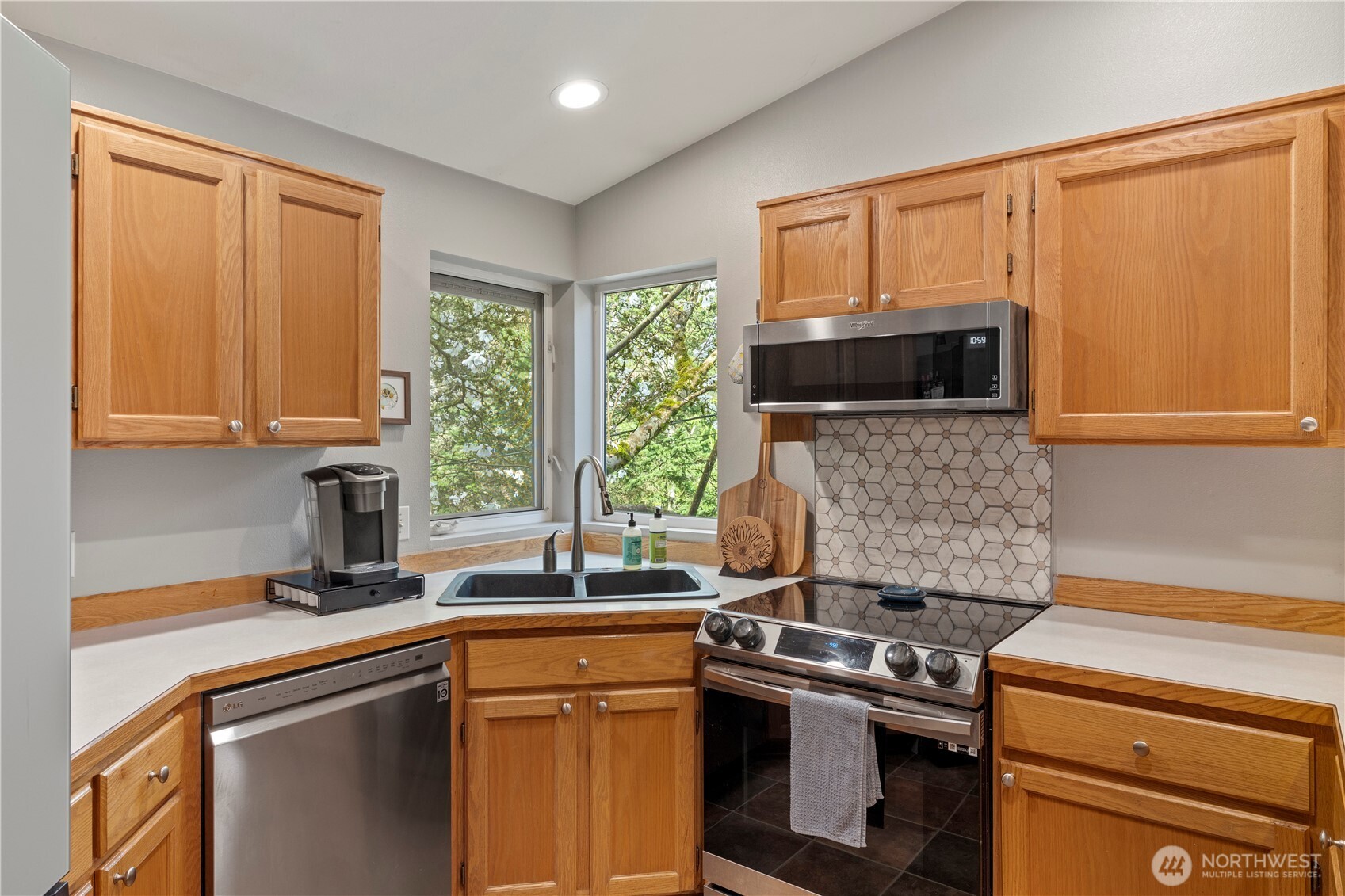 6352 24th Avenue Southwest Seattle, WA 98106 - Photo 6 of 31 a kitchen with a sink stove and microwave