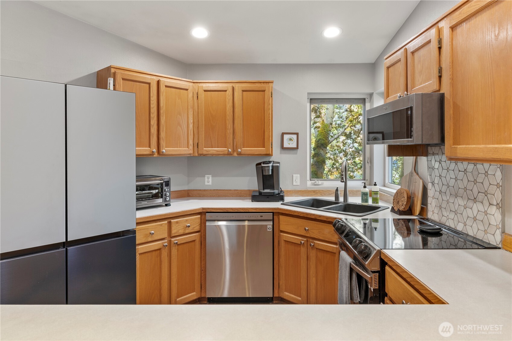 6352 24th Avenue Southwest Seattle, WA 98106 - Photo 7 of 31 a kitchen with stainless steel appliances granite countertop a sink stove and refrigerator