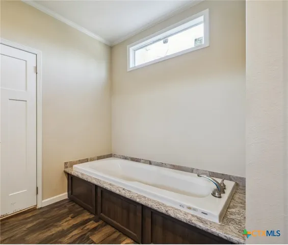 a living room with furniture a flat screen tv and a window