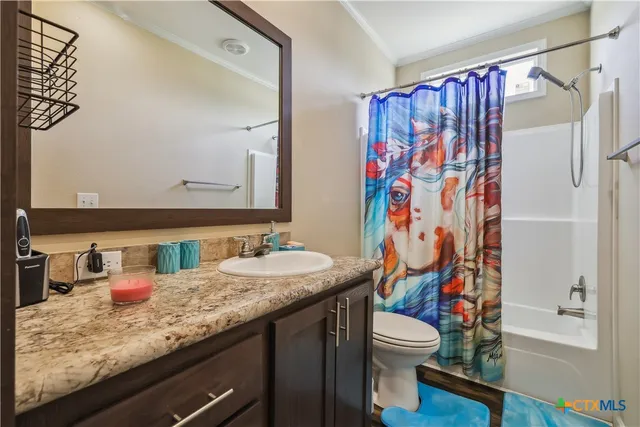 a bedroom with a large bed and a ceiling fan