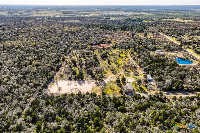 an aerial view of residential house and car parked