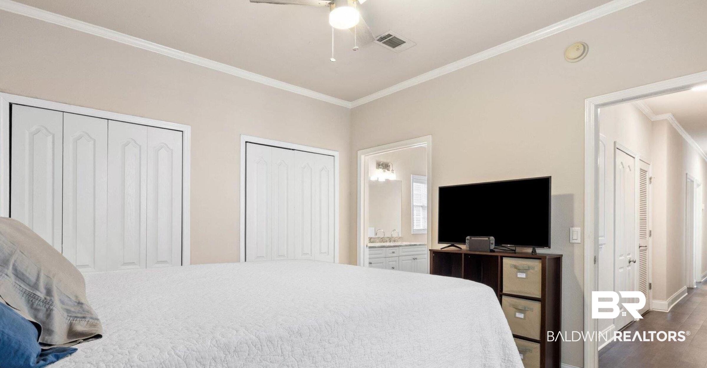 25806 Pollard Road, Unit 203 Daphne, AL 36526 - Photo 9 of 14 Carpeted bedroom featuring multiple closets, crown molding, ceiling fan, and connected bathroom