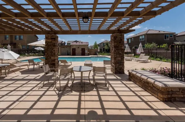 a view of a porch with a table and chairs