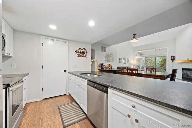 a kitchen with granite countertop a sink and cabinets