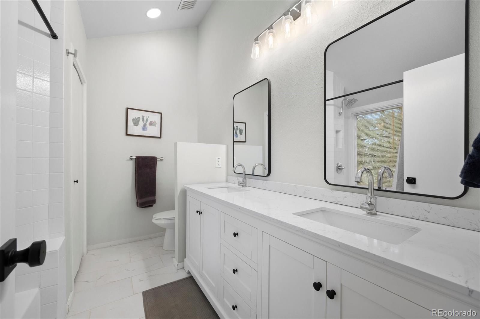 23551 Genesee Village Road, Unit H Golden, CO 80401 - Photo 17 of 40 a bathroom with a double vanity sink mirror and