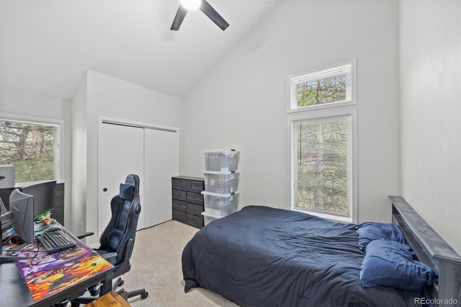 23551 Genesee Village Road, Unit H Golden, CO 80401 - Photo 19 of 40 a bedroom with a bed and wooden floor