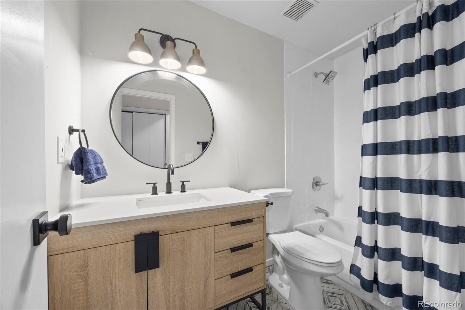 23551 Genesee Village Road, Unit H Golden, CO 80401 - Photo 21 of 40 a bathroom with a sink toilet and mirror