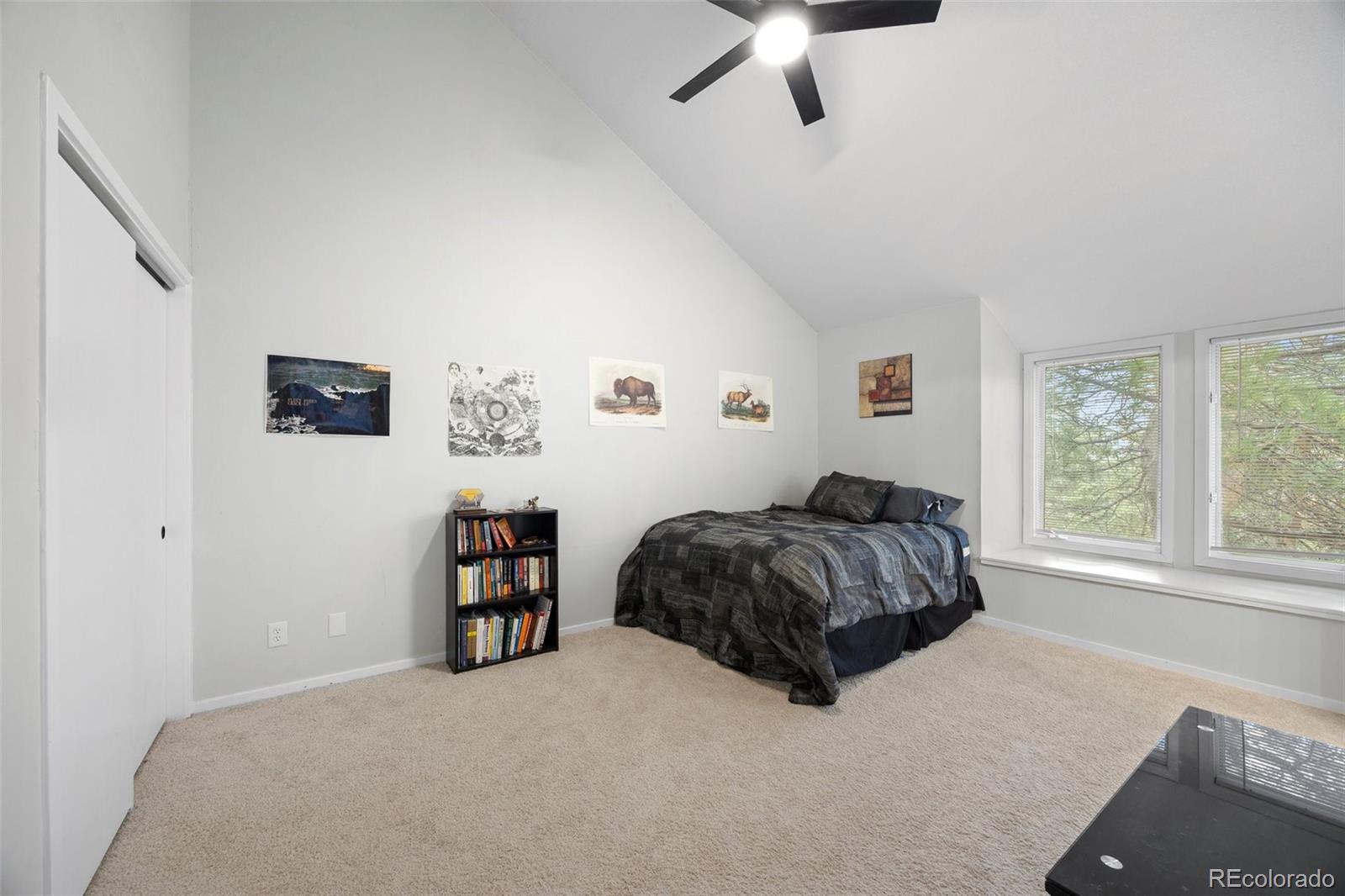 23551 Genesee Village Road, Unit H Golden, CO 80401 - Photo 22 of 40 a living room with a bed furniture and a window