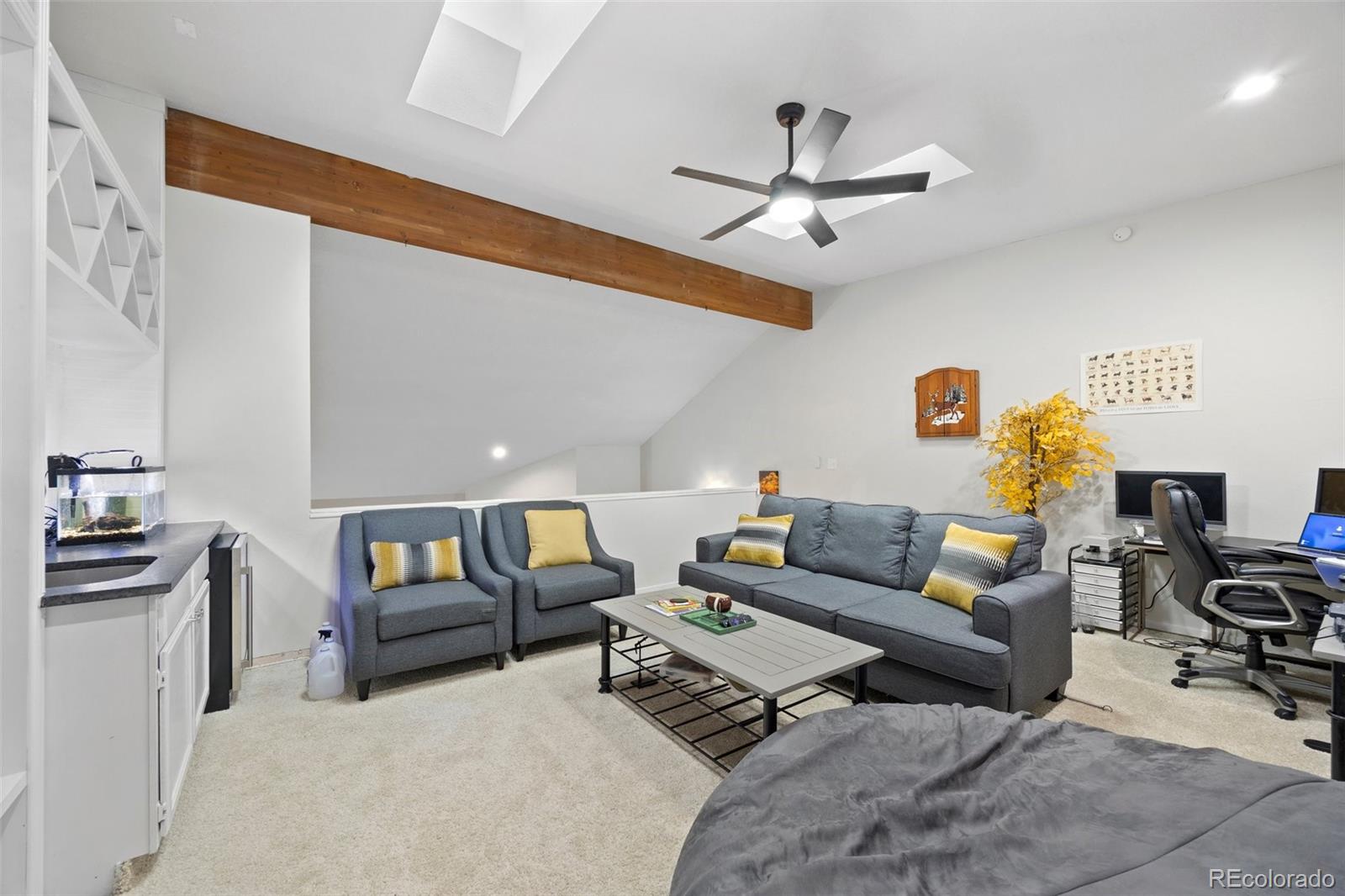 23551 Genesee Village Road, Unit H Golden, CO 80401 - Photo 23 of 40 a living room with furniture and a ceiling fan