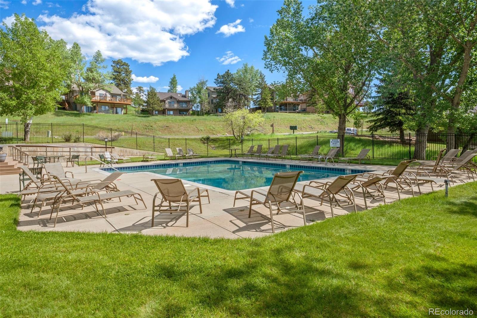 23551 Genesee Village Road, Unit H Golden, CO 80401 - Photo 28 of 40 a view of a swimming pool and outdoor space