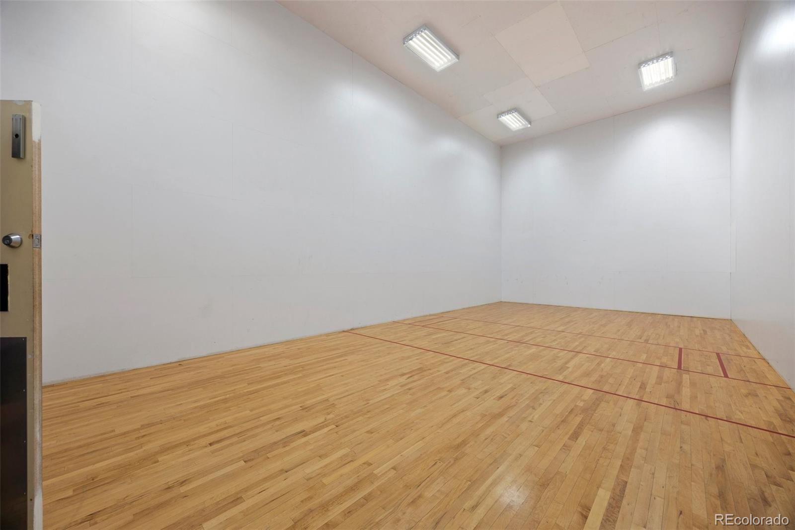 23551 Genesee Village Road, Unit H Golden, CO 80401 - Photo 29 of 40 an empty room with wooden floor and windows