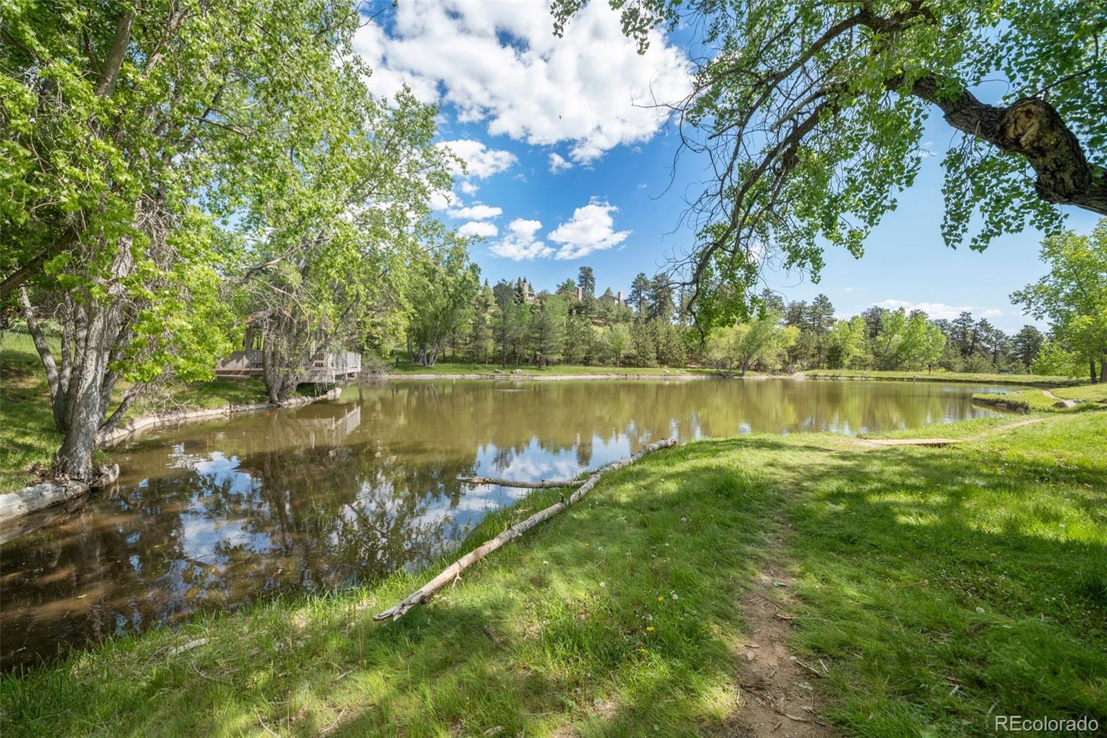 23551 Genesee Village Road, Unit H Golden, CO 80401 - Photo 34 of 40 a view of a lake with a big yard