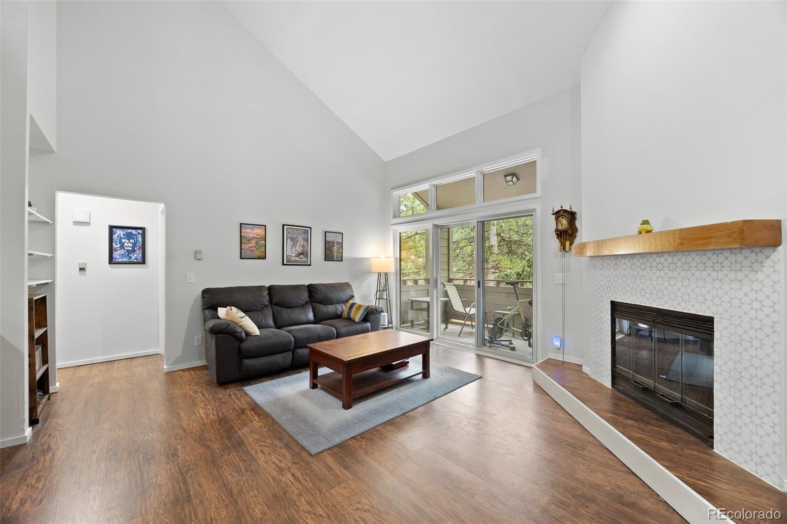 23551 Genesee Village Road, Unit H Golden, CO 80401 - Photo 6 of 40 a living room with furniture and a fireplace