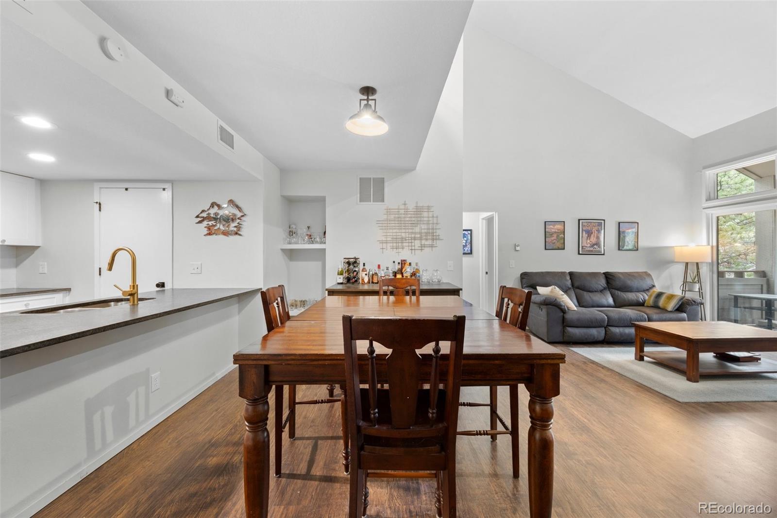 23551 Genesee Village Road, Unit H Golden, CO 80401 - Photo 9 of 40 a view of a dining room with furniture and wooden floor