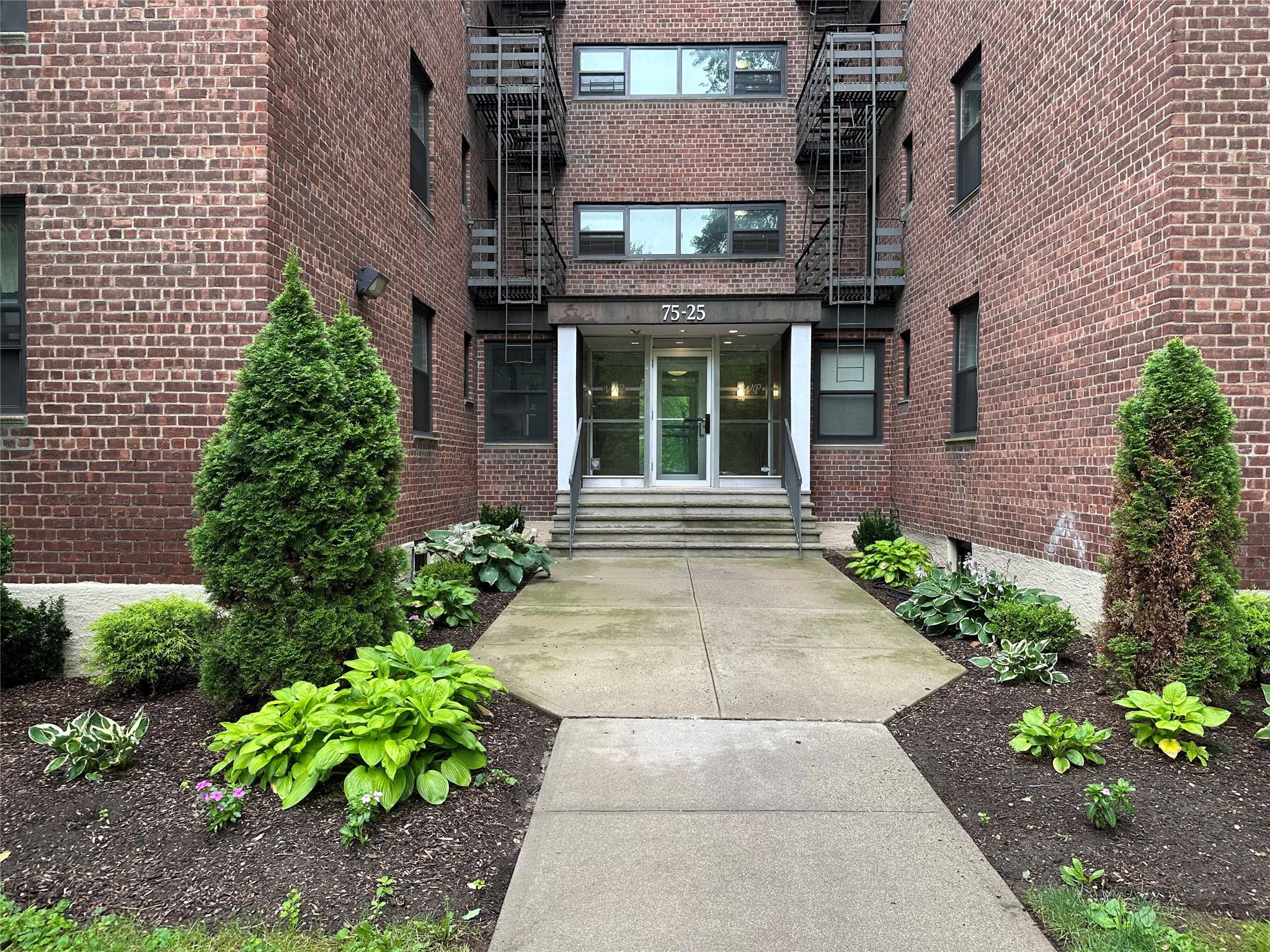 75-25 210th Street, Unit 4L Queens, NY 11364 - Photo 1 of 1 a view of a brick building with potted plants