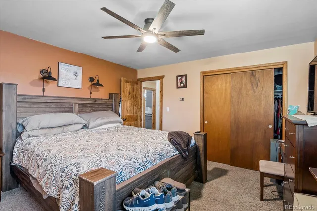 a bedroom with a large bed and a chandelier