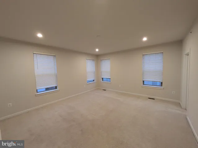 an empty room with windows and closet