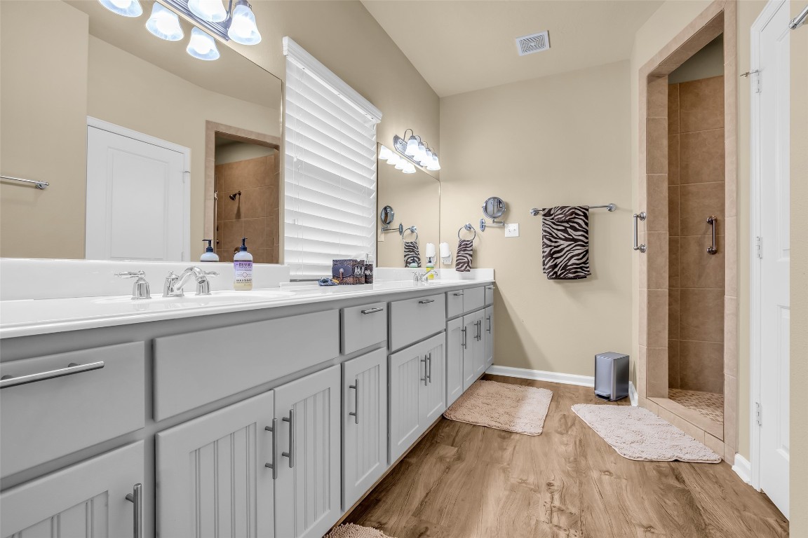209 East George Jones Road Livingston, TX 77351 - Photo 11 of 26 There is no shortage of storage in the primary ensuite with a full wall of cabinets and floor to ceiling cabinet near the entry.