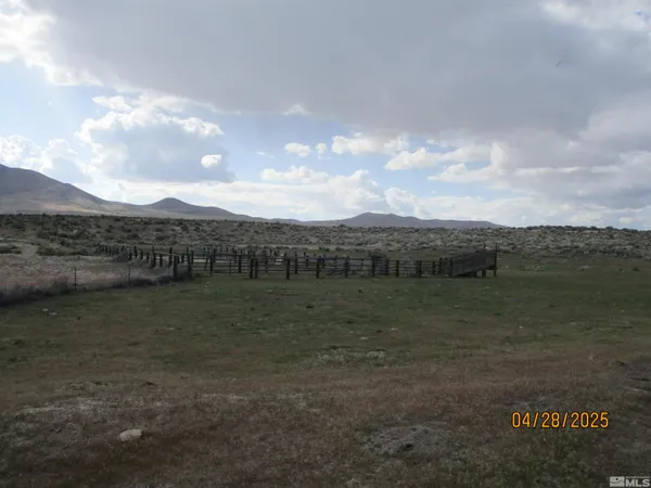 a view of a lake with houses in back