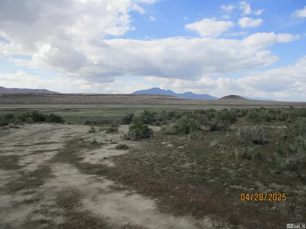 a view of a town with mountains in the background
