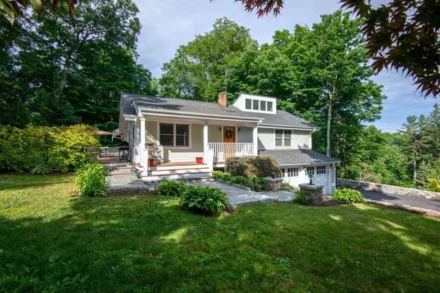 a front view of house with yard and green space